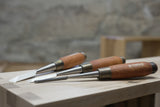 Three dovetail chisels with hornbeam wood handle with a brass ferrule and metal striking ferrule.