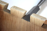 Dovetail chisel reaching all the way into internal corner.